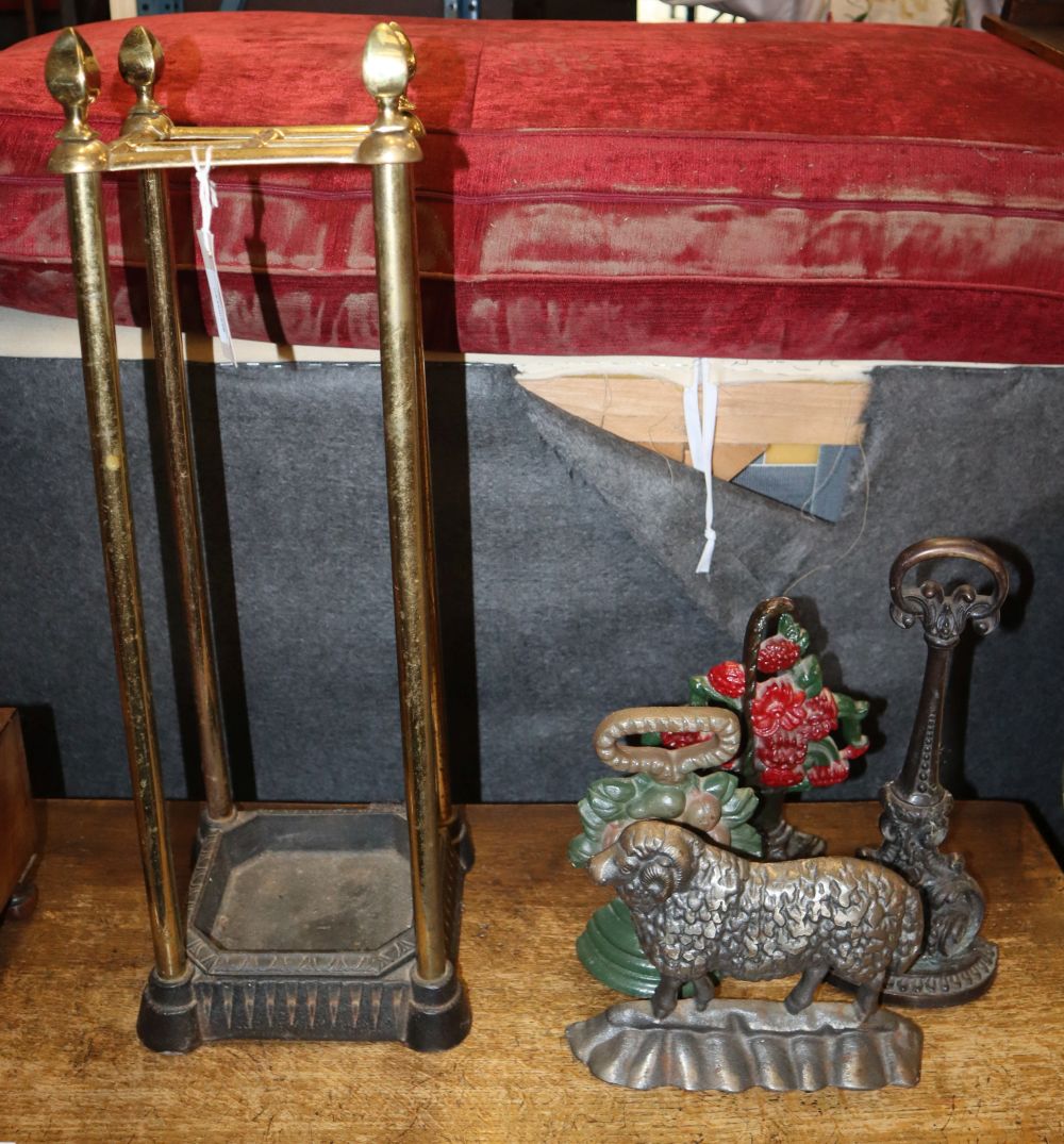 A late Victorian brass and cast iron stick, H.63cm, together with an umbrella stand and three cast iron doorstops (4)